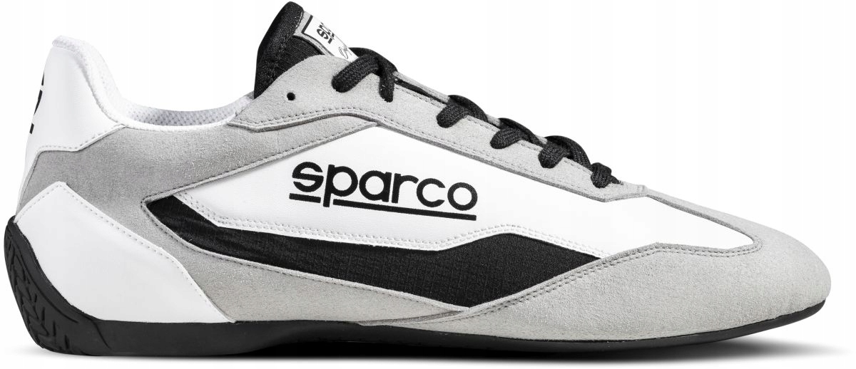 Sparco S-Drive shoes in white and black, featuring a sleek design with a suede and synthetic upper, black laces, and a prominent Sparco logo on the side. Size UK 9 / EUR 43.