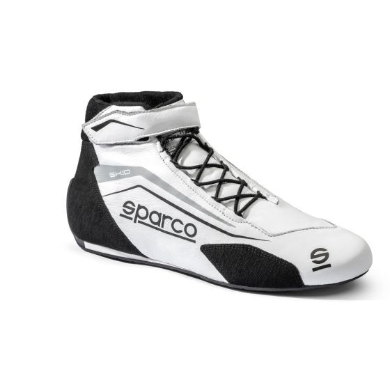 White and black Sparco Skid Race Boots featuring a sleek design, lace-up front, ankle support, and a prominent logo, available in UK size 8 / EUR 42.