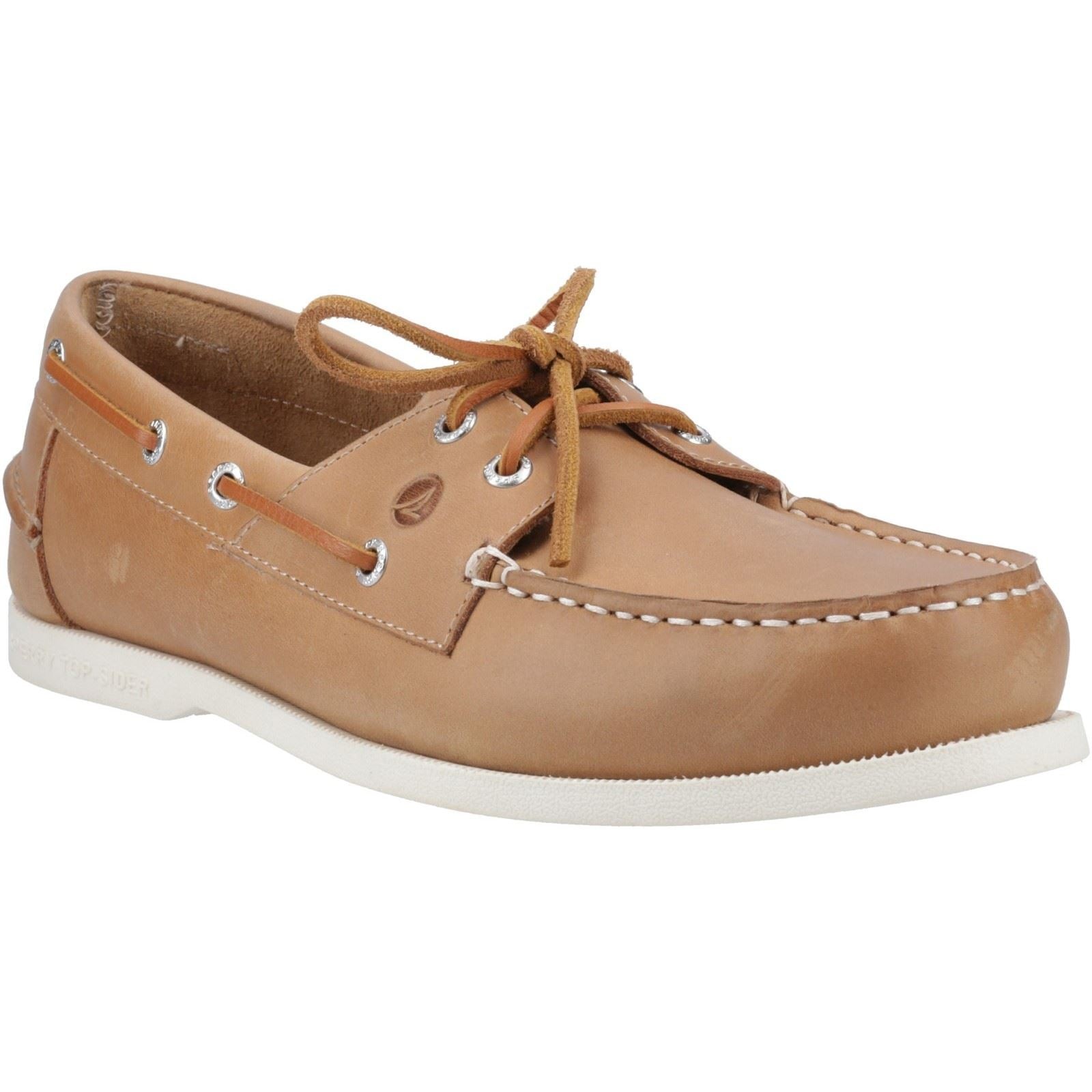 Camel-colored leather boat shoe with a white rubber sole, featuring classic lacing, metal eyelets, and a stitched toe design.