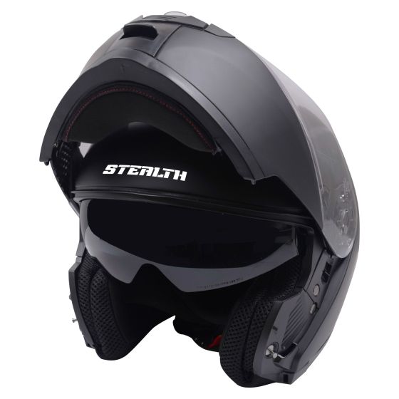 Matte black flip-up helmet with a sleek design, featuring a tinted visor, ventilation ports, and the "STEALTH" logo prominently displayed on the front.