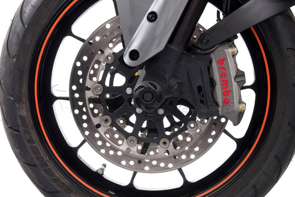 Black SW Motech front axle slider set for KTM Super Duke 1290 (2016-2020), featuring a sleek design, durable material, and visible Brembo brake caliper with red lettering.