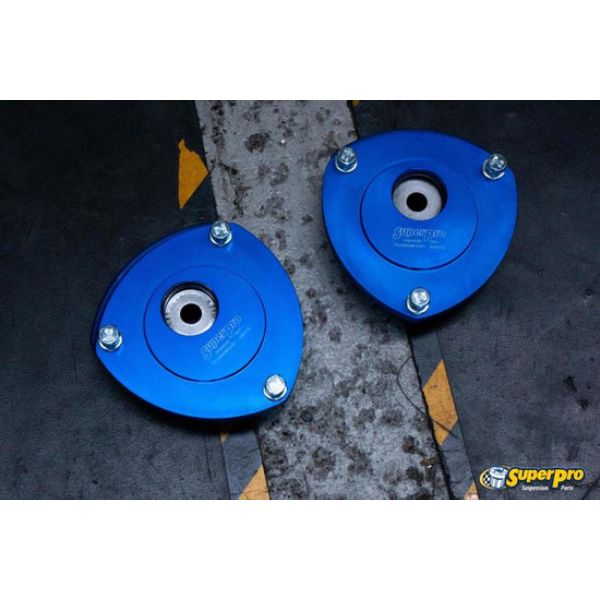 Blue aluminum front upper fixed camber offset strut mounts with a circular design, featuring a central hole and secured by four bolts, designed for 2015 Audi A3 Quattro Premium.