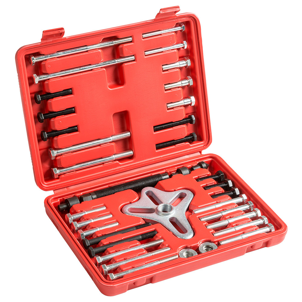 Red plastic case containing a universal steering wheel puller set with various metal bolts and tools arranged neatly inside.