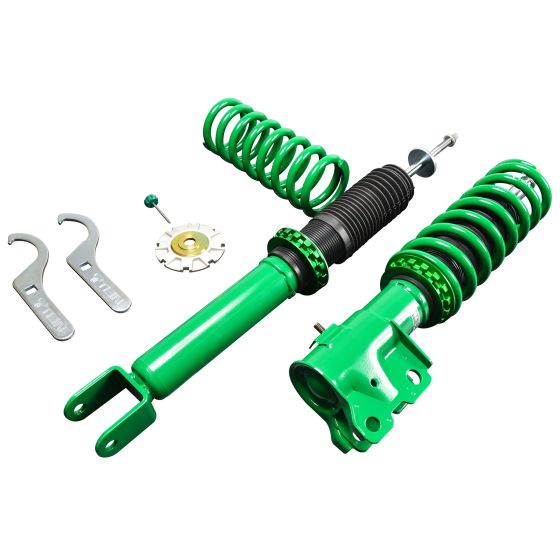 Tein Street Advance Z Coilovers in vibrant green, featuring adjustable springs, a black rubber sleeve, and included tools for installation.