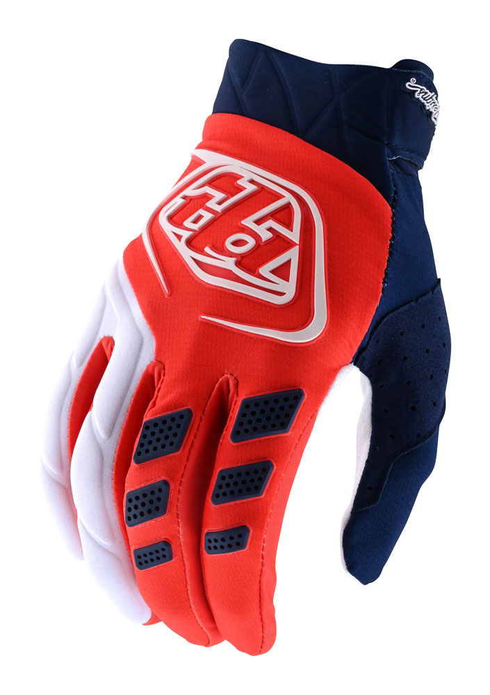 Orange and navy textile gloves featuring a prominent white logo, padded knuckles, and perforated sections for breathability.