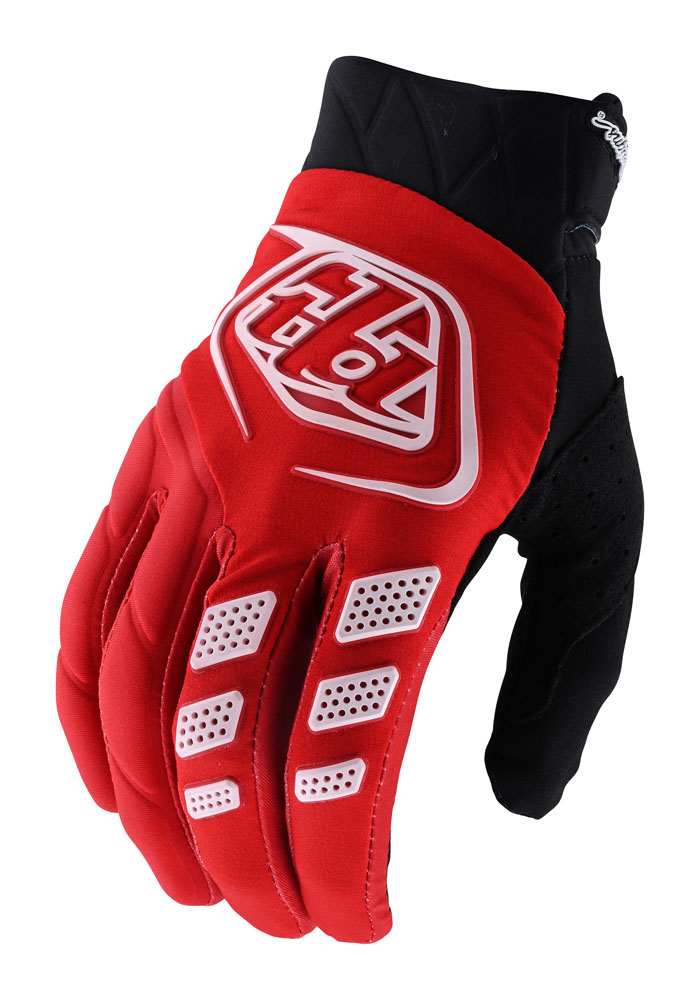 Red textile gloves with black accents, featuring a textured grip, perforated panels for breathability, and a prominent white Troy Lee Designs logo on the back.