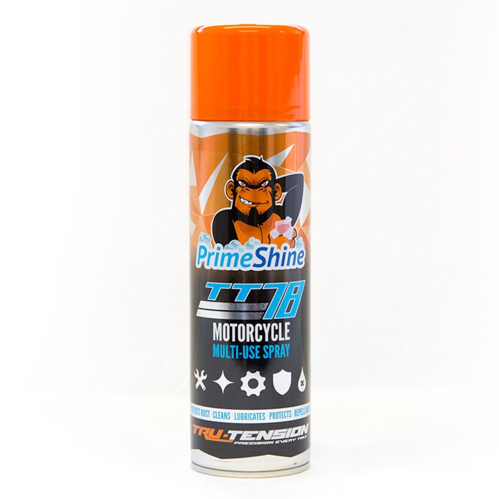 Tru Tension PrimeShine TT78 Multi-Use Spray in a 500ml can features an orange cap, vibrant graphics, and icons indicating cleaning, lubrication, and protection for motorcycles.