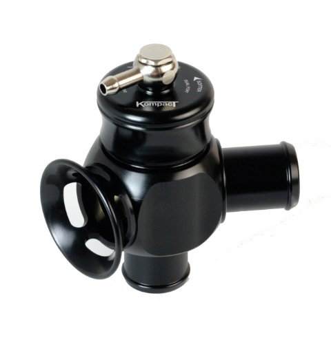 Black aluminum blow-off valve with a dual port design, featuring a polished metal actuator, a large outlet, and a compact shape, labeled "Kompact" on top.