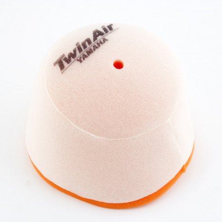 Twin Air air filter in a dome shape, featuring a light pink foam material with an orange base, and a small hole at the top, marked with the "TwinAir" logo.