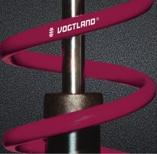 Vogtland Club Lowering Suspension Kit features a vibrant purple coil spring with a metallic finish, designed to lower the front by 25mm and the rear by 35mm for enhanced performance.