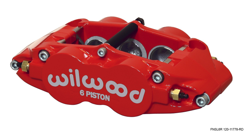 Bright red forged aluminum caliper with "wilwood" logo, featuring six pistons and radial mount design, showcasing a sleek and robust construction for high-performance braking.