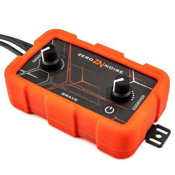 Bright orange intercom amplifier with a textured black panel, featuring two large knobs labeled "DRIVER" and "BRAVE," and a power button, designed for male Nexus connectors.