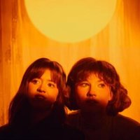 "Lemoncello" vinyl record by Vinyl Castle featuring two women under a warm yellow light, creating a nostalgic ambiance.