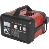 Red and black Sealey CHARGE124 automotive battery charger with handle, analog display, and multiple switches.