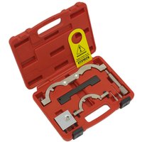 Red Sealey timing tool kit with metal components, black foam insert, and yellow warning tag in a sturdy case.