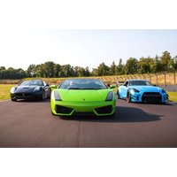Green Lamborghini flanked by black Ferrari and blue Nissan on a racetrack, part of a driving experience package.