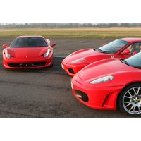 Red Ferrari supercars with sleek design and V8 engines parked on a racetrack.