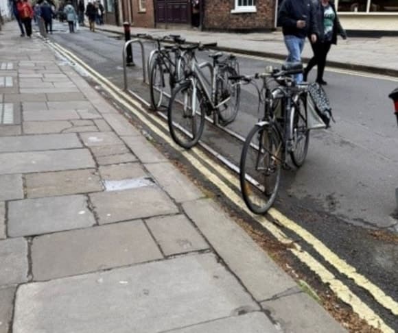 Bicycles parked on a cobblestone street in a Yorkshire town