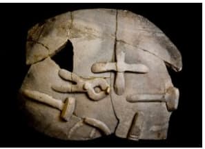 Ancient stone artifact with intricate carvings, showcasing historical significance at Malton Museum, Yorkshire.