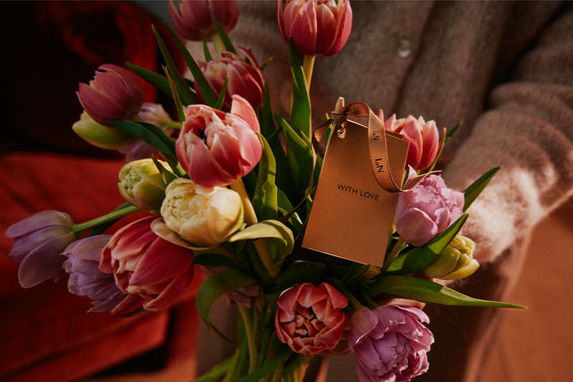 Bouquet of pink, yellow, and purple tulips with a gift tag