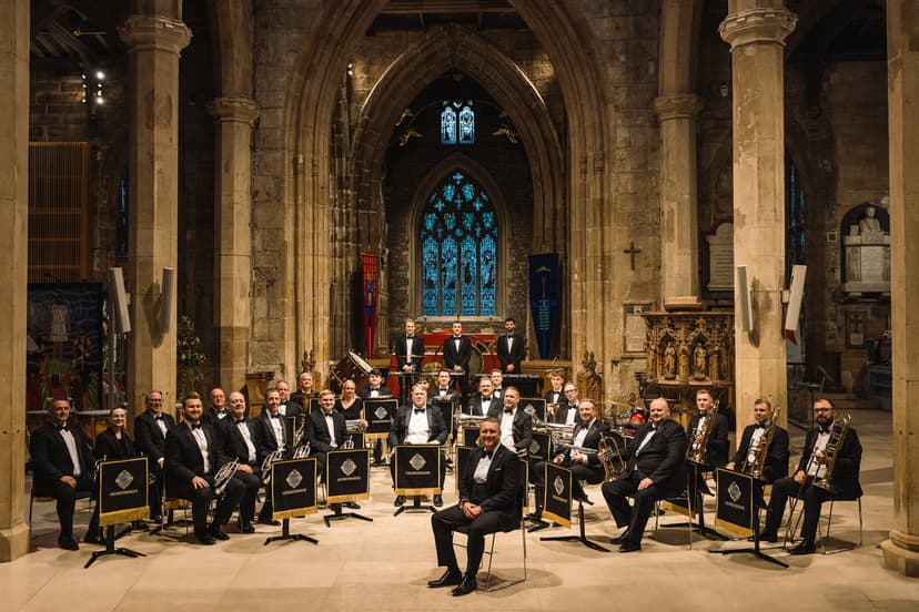 Orchestra in formal attire performing in historic church