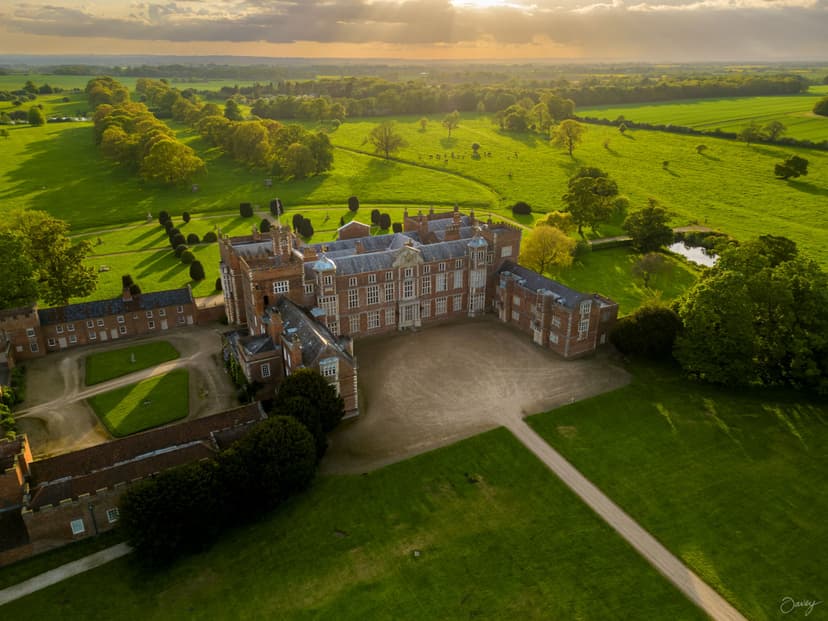 Aerial view of Burton Constable Hall surrounded by lush green fields