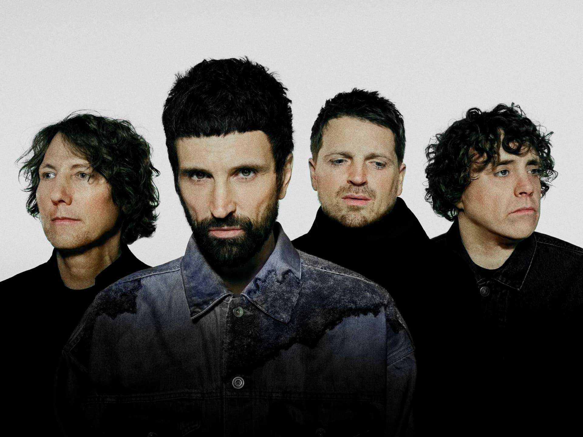 Four men with serious expressions against a white background