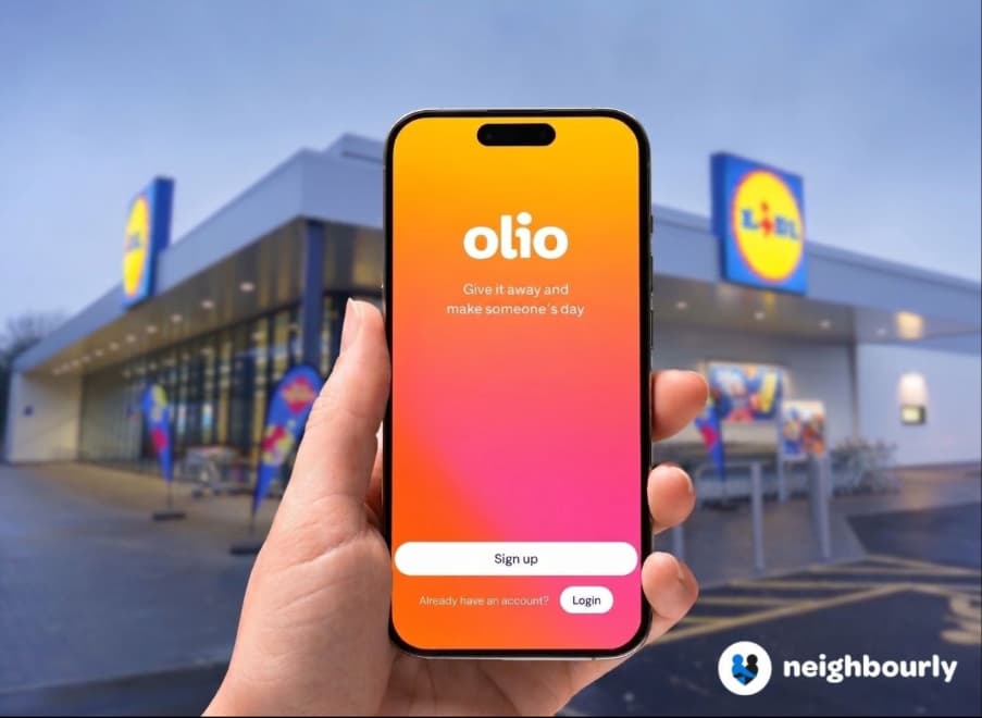 Hand holding smartphone with Olio app in front of Lidl store
