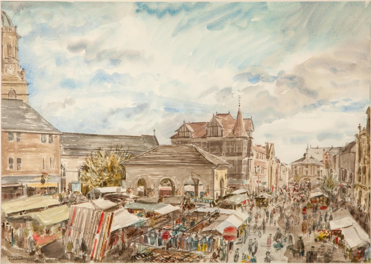 Vibrant market scene in Pontefract, with historic buildings and bustling stalls under a cloudy sky.