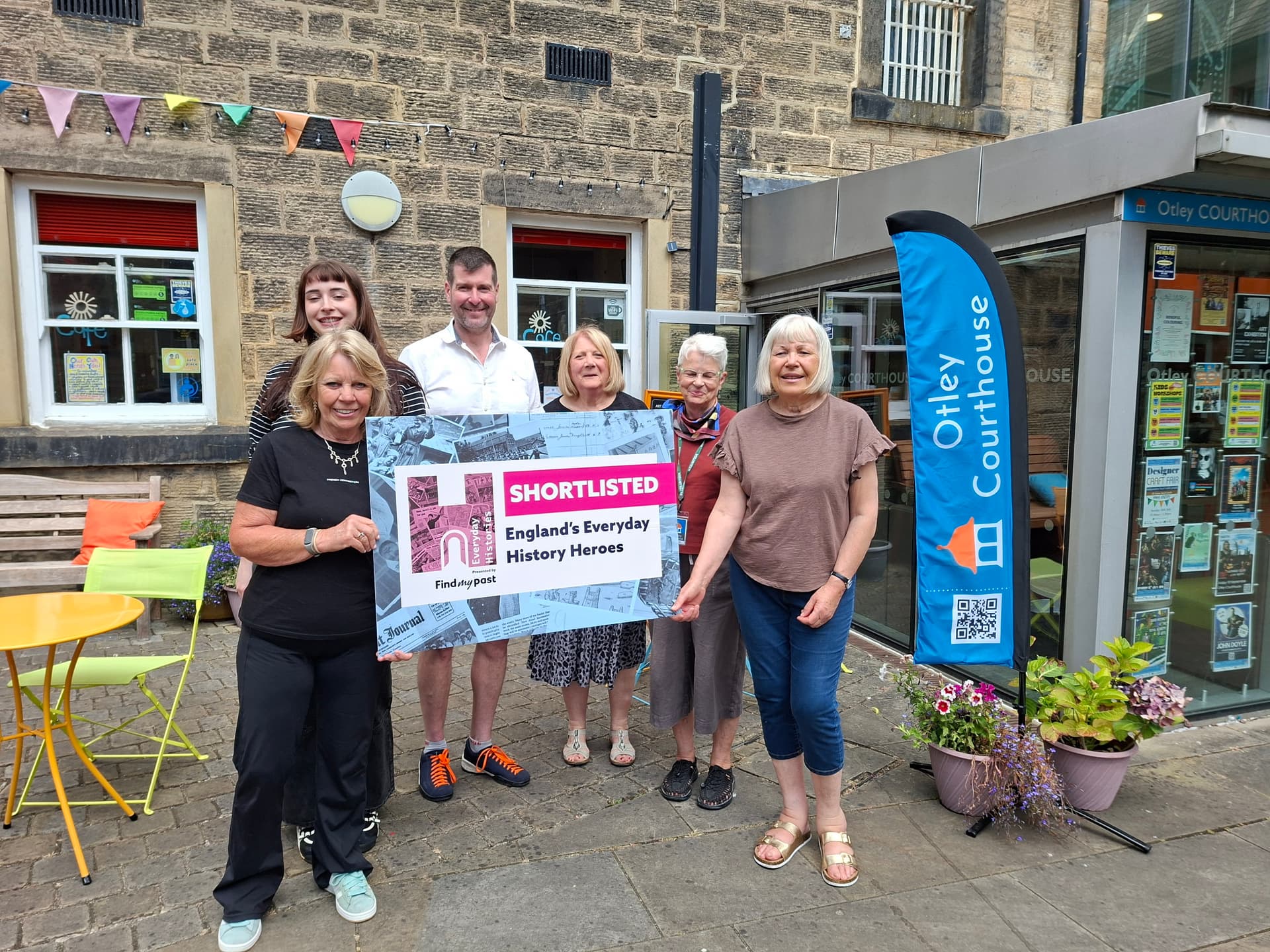 Group of people holding a sign outside Otley Courthouse