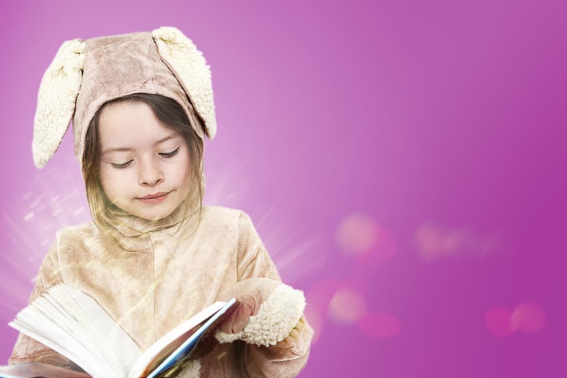 Girls in fancy dress reading a book