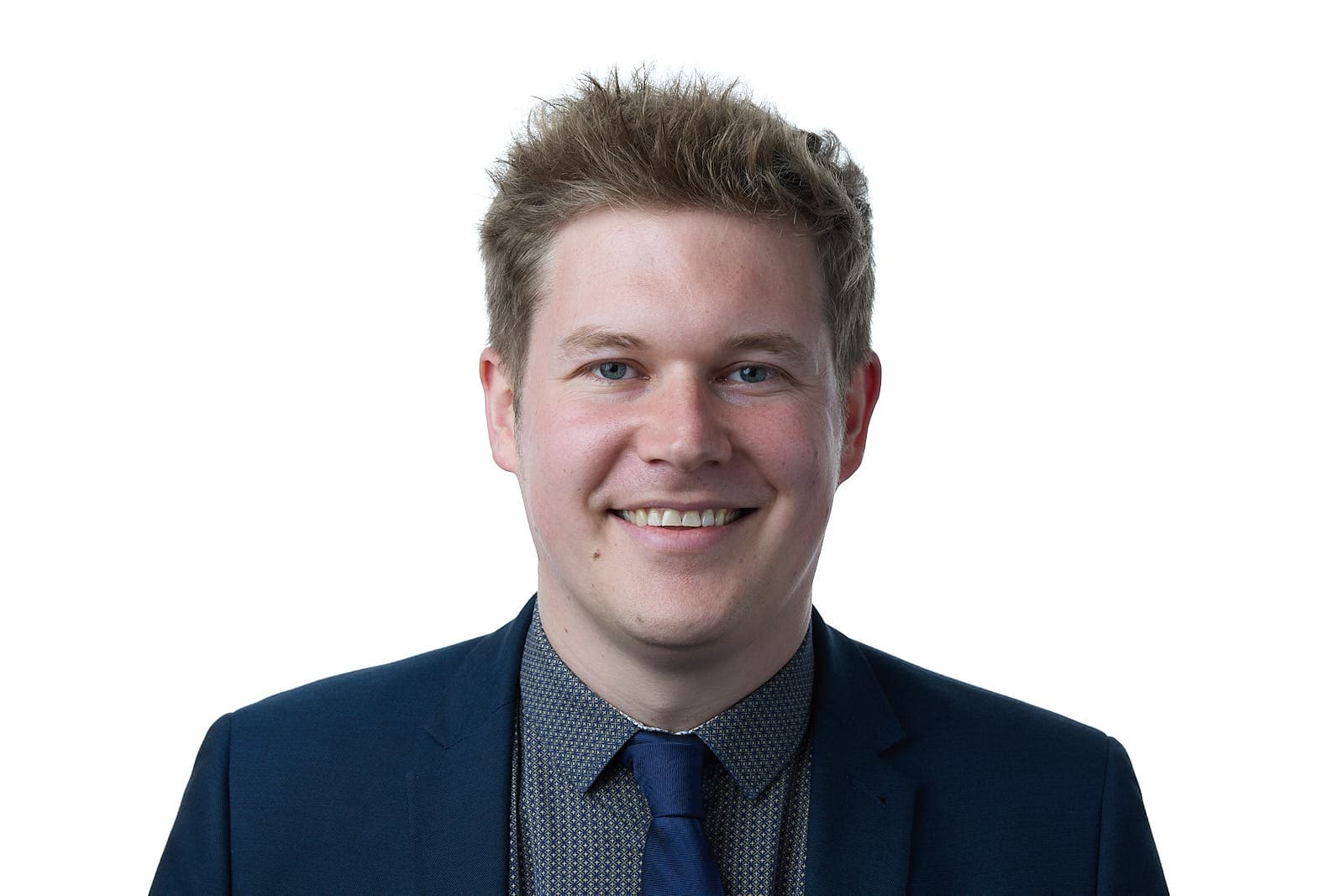 Smiling person in a blue suit against white background