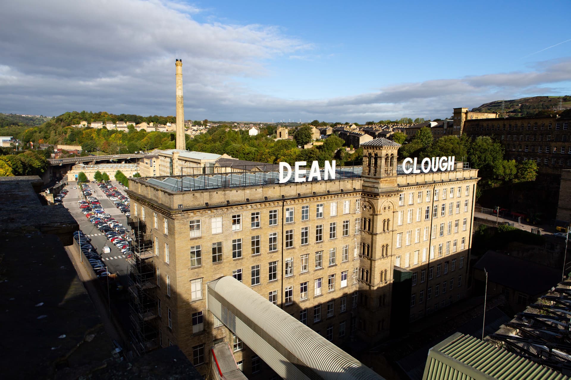 Historic brick mill complex with tower in sunny Yorkshire