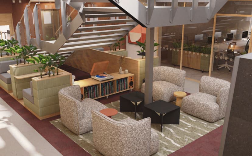 Modern workspace featuring cozy seating areas, greenery, and a staircase, designed for collaboration and comfort at Carrwood Park.