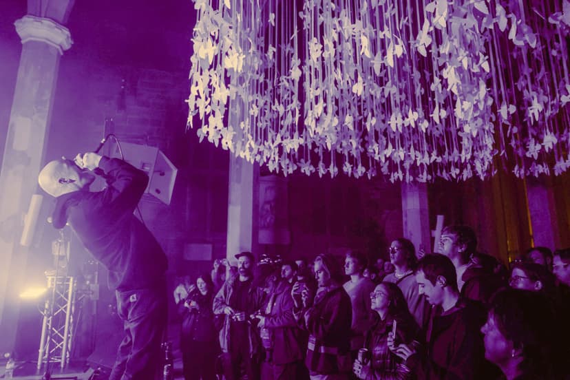 Concert in historic venue with crowd and ceiling art