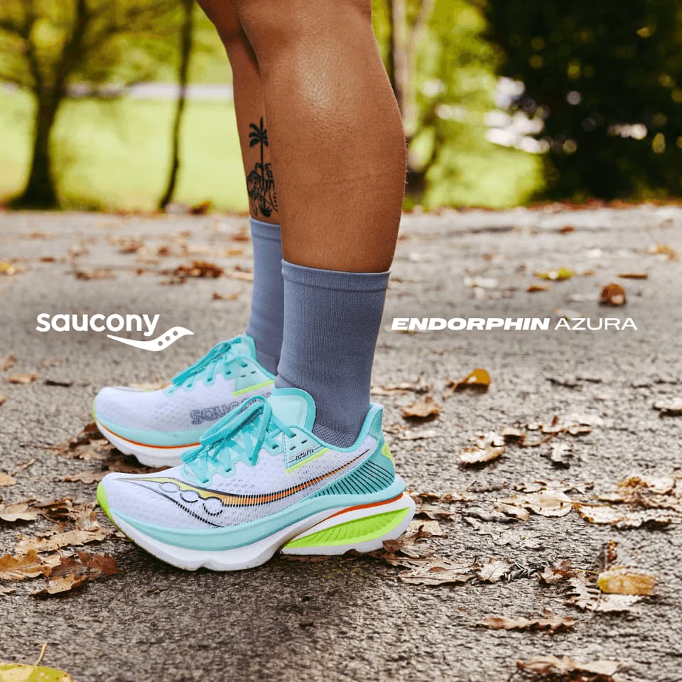 Runner wearing turquoise trainers on leafy path in autumn park