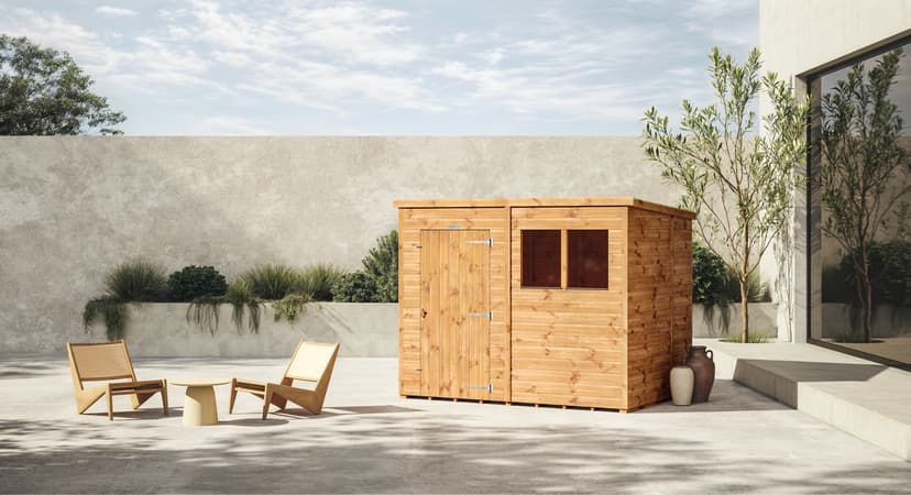 Modern wooden sauna with chairs on sunlit patio