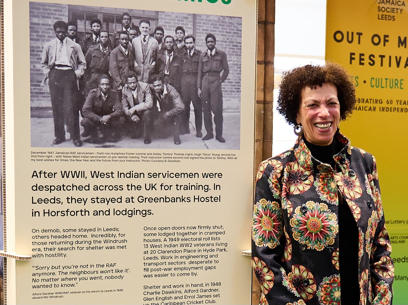 Woman standing next to a historical display about West Indian servicemen