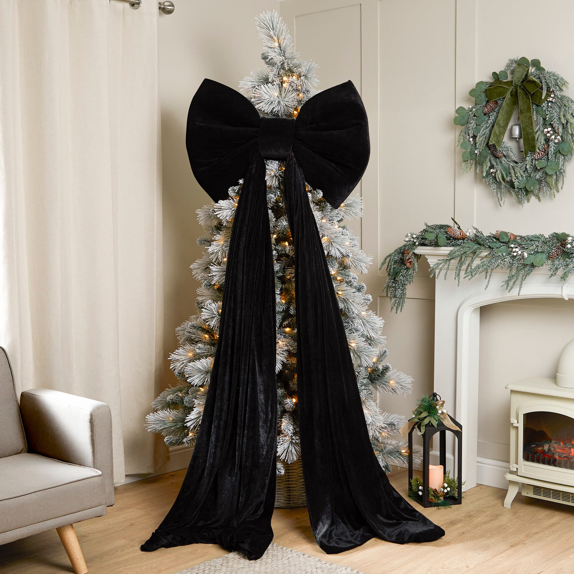 Festive living room with flocked Christmas tree and black bow