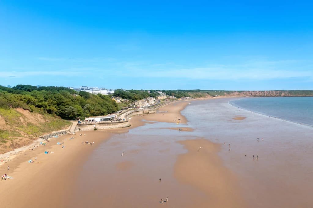 Scarborough beach with sandy shore and distant cliffs