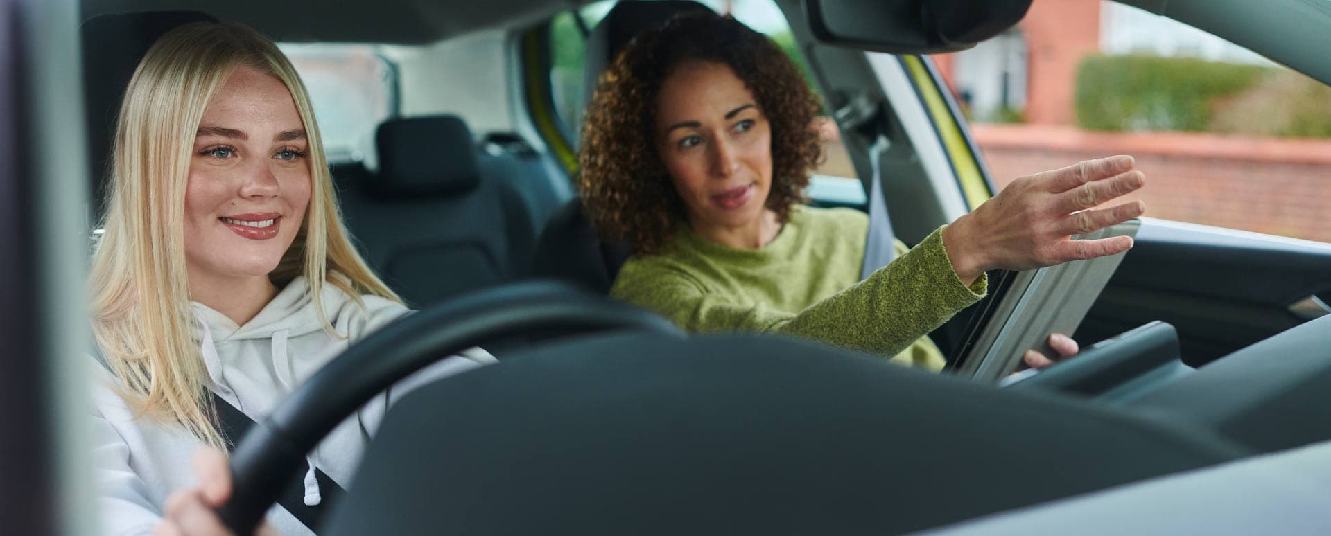 Driving lesson with instructor and student in car