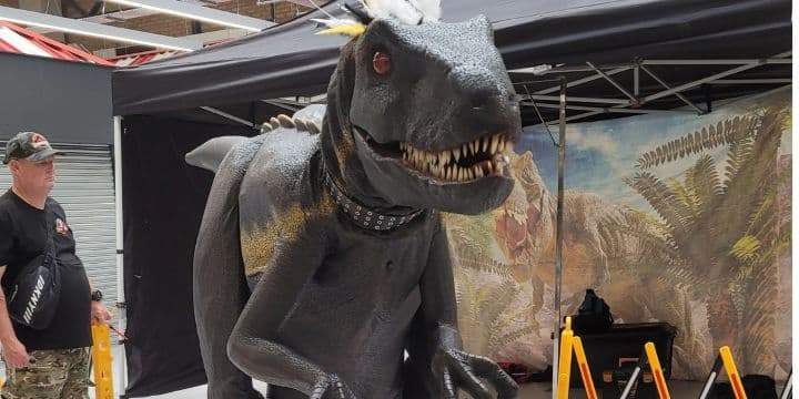 Lifelike dinosaur model with sharp teeth in exhibition tent