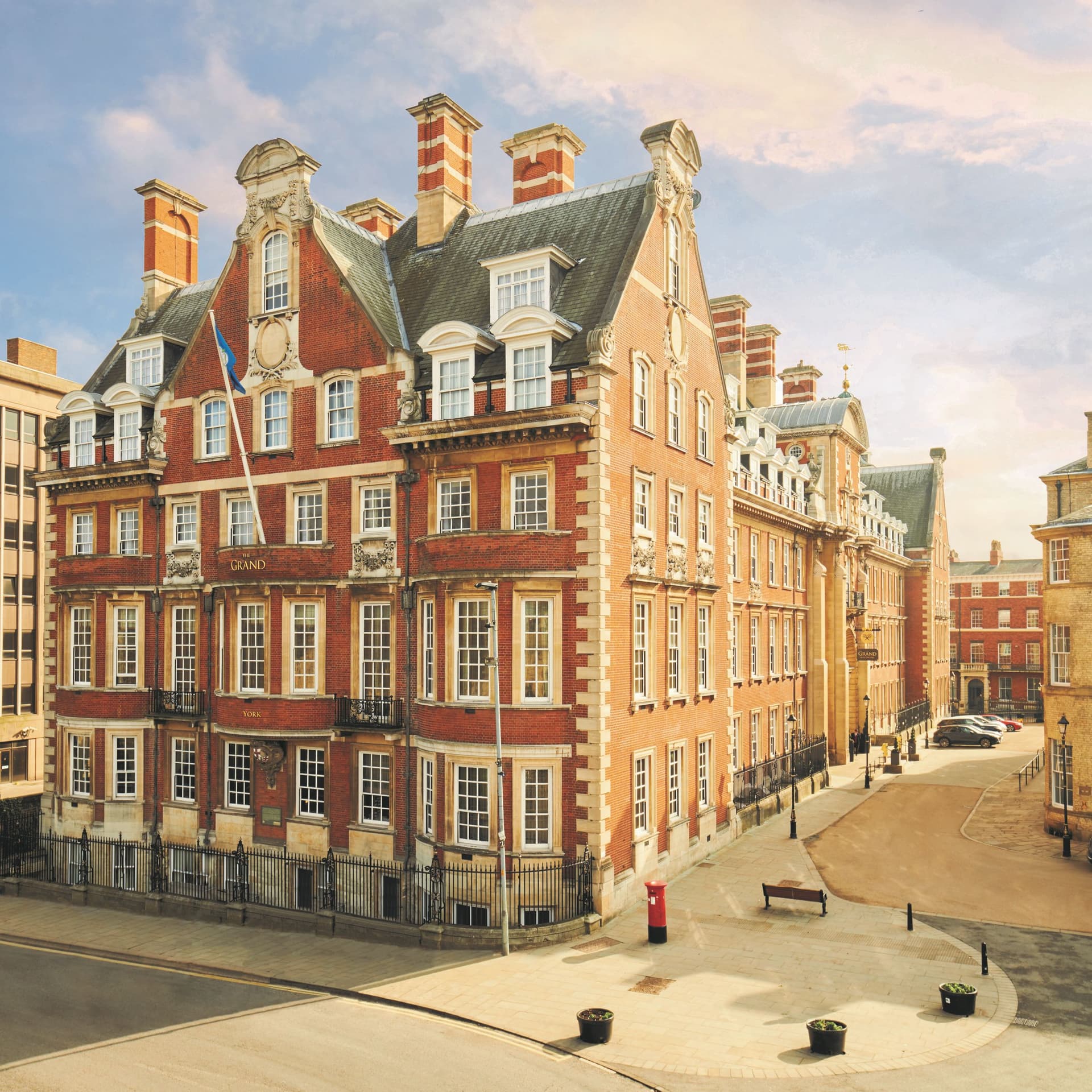 Historic red-brick hotel with ornate windows and chimneys