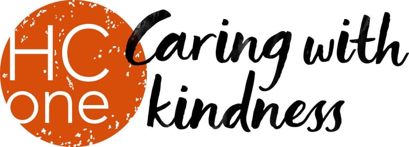 Bright logo featuring "HC One" in orange and "Caring with kindness" in elegant black script, evoking warmth and community.