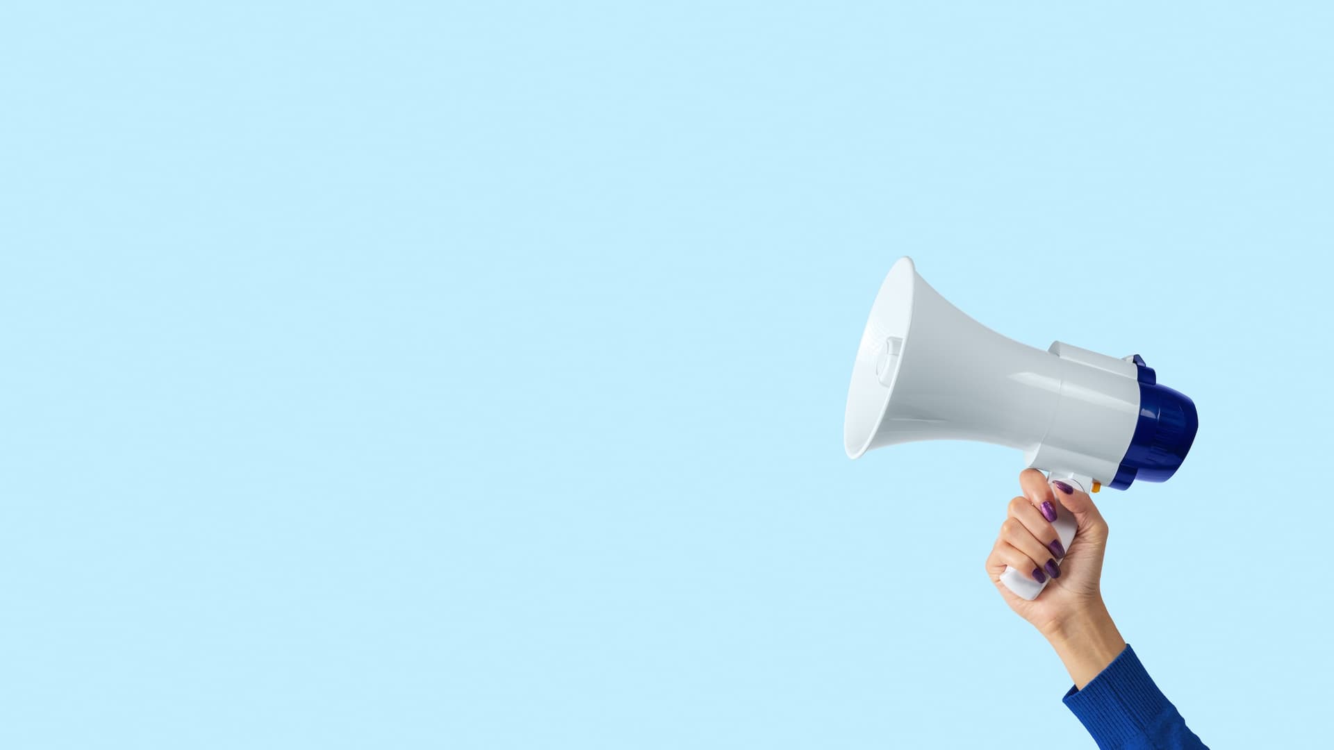 Hand holding a white megaphone against a light blue background
