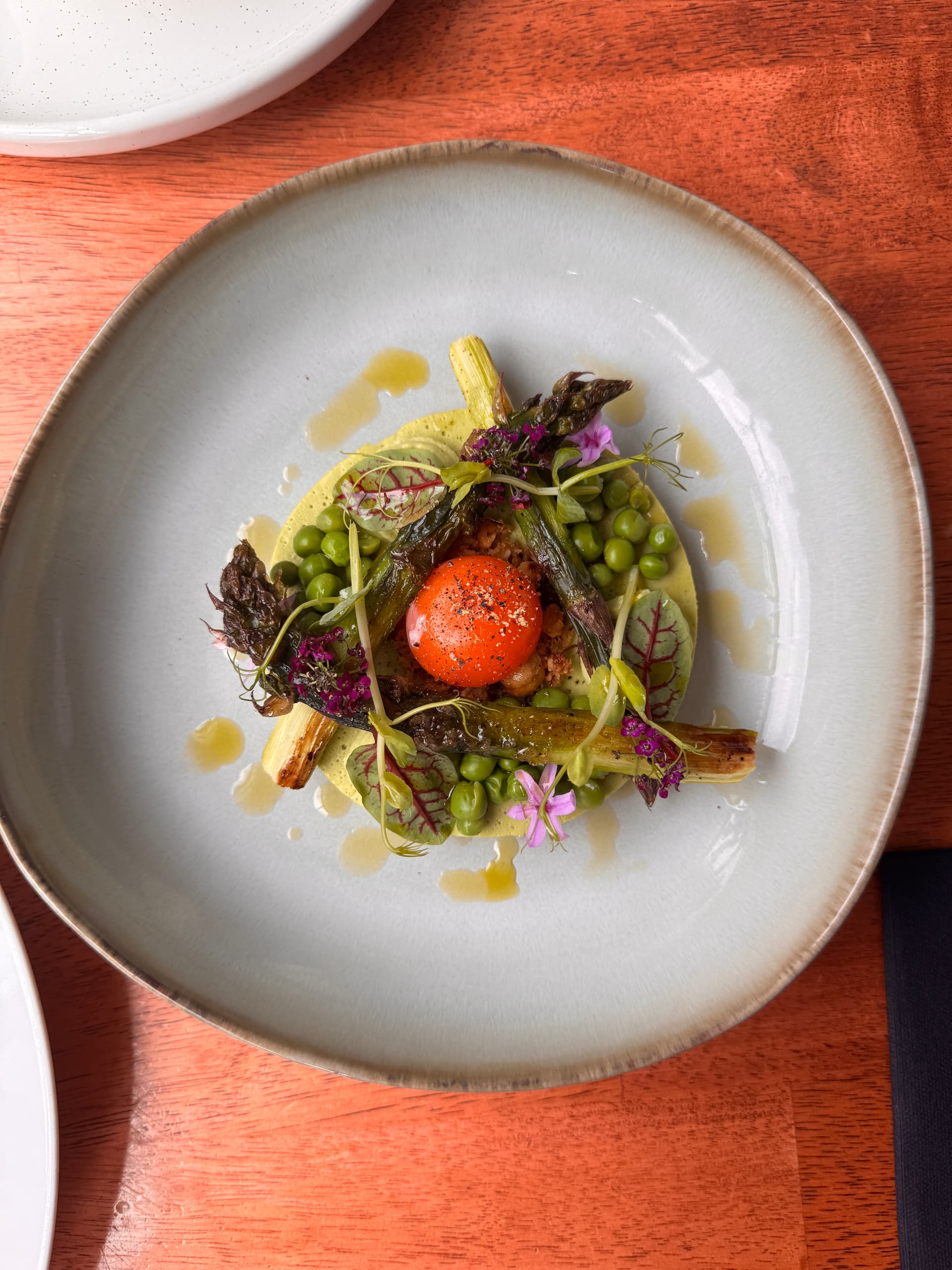 Gourmet dish with vegetables and a bright orange center