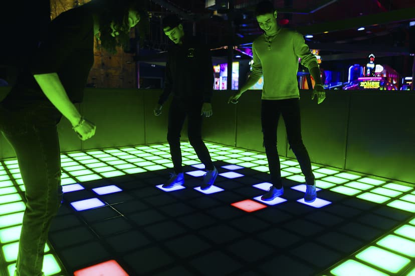 People enjoying interactive illuminated dance floor