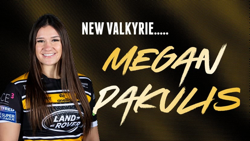 Smiling female rugby player in yellow and black jersey