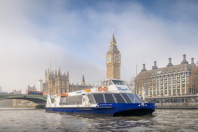 Riverboat cruising past Big Ben and Houses of Parliament