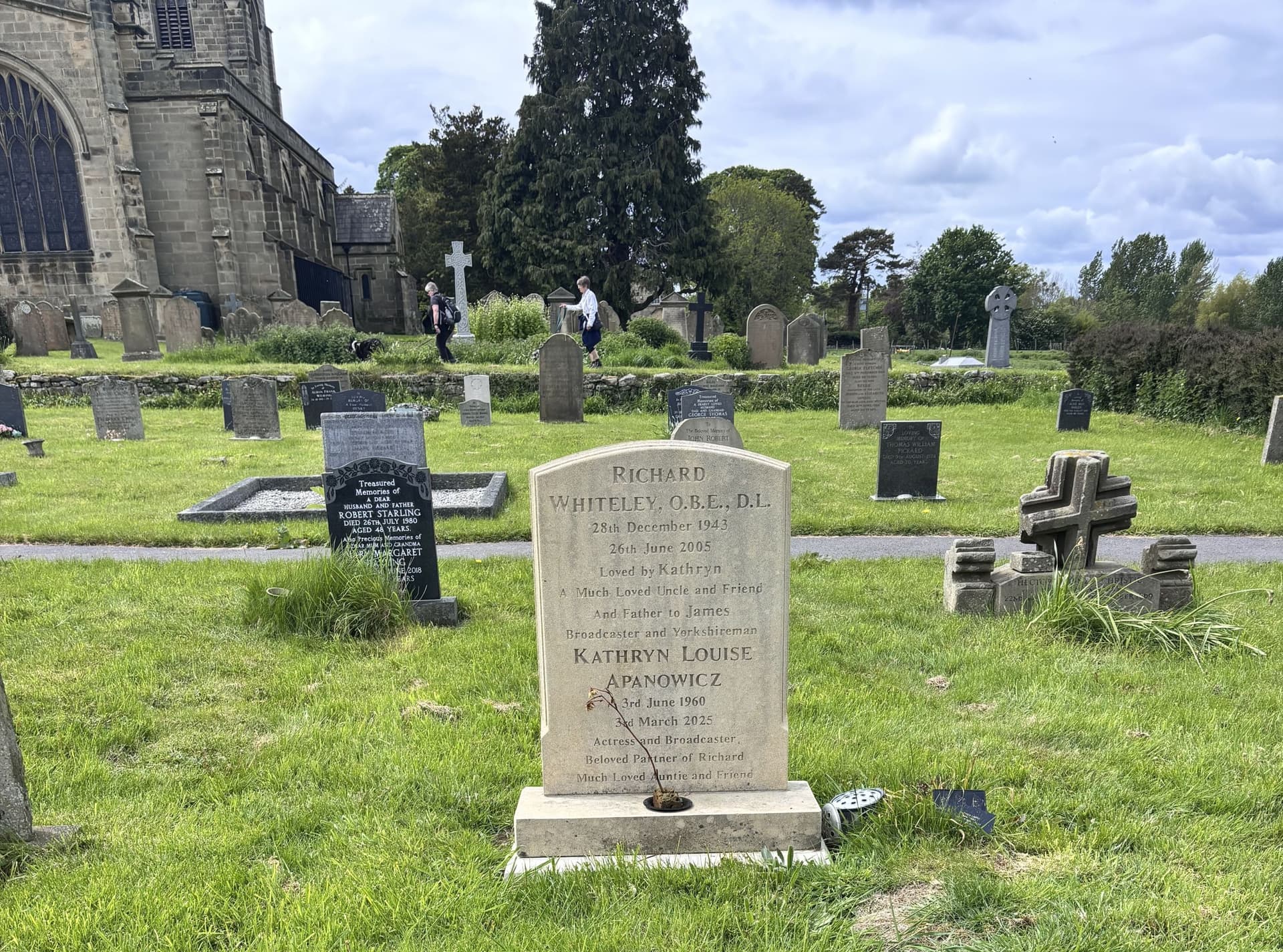 Historic churchyard with gravestones and lush greenery